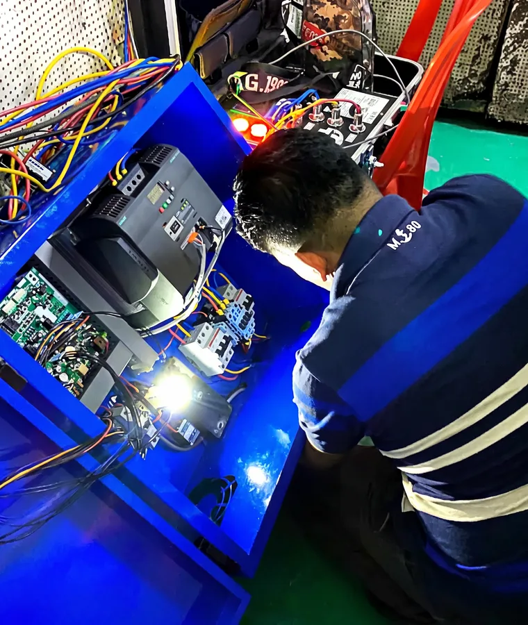 Agile Strategies engineer assembling and wiring a DVDC control panel in the Kuala Lumpur workshop