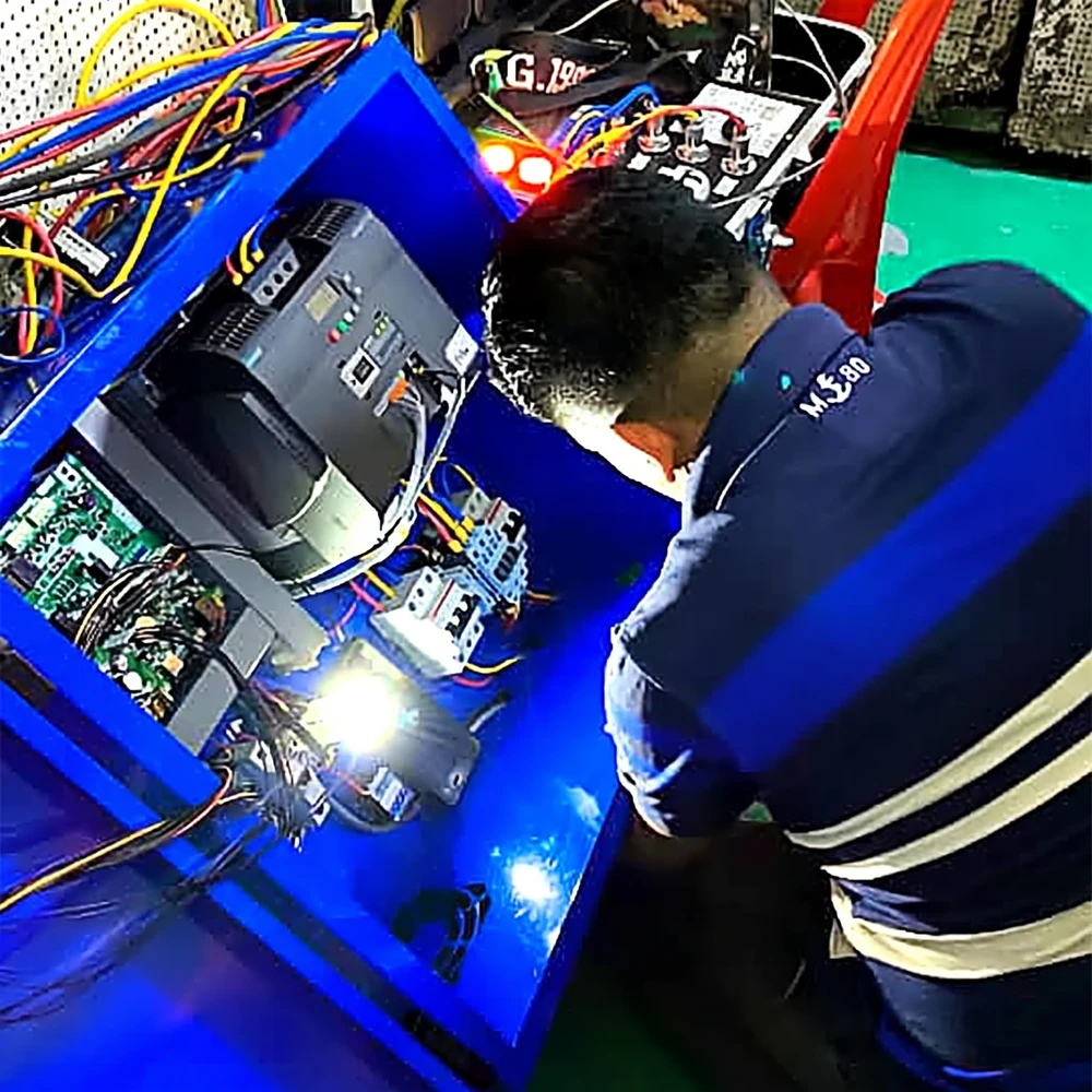Agile Strategies engineer wiring a DVDC control panel in the Kuala Lumpur workshop