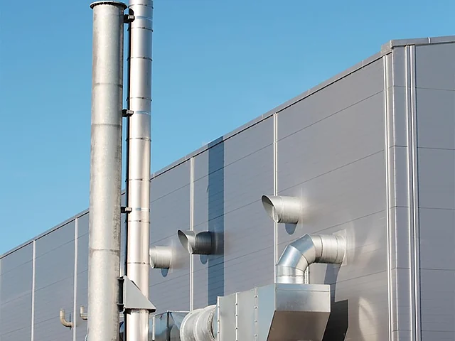 Industrial exhaust stacks serving a large facility