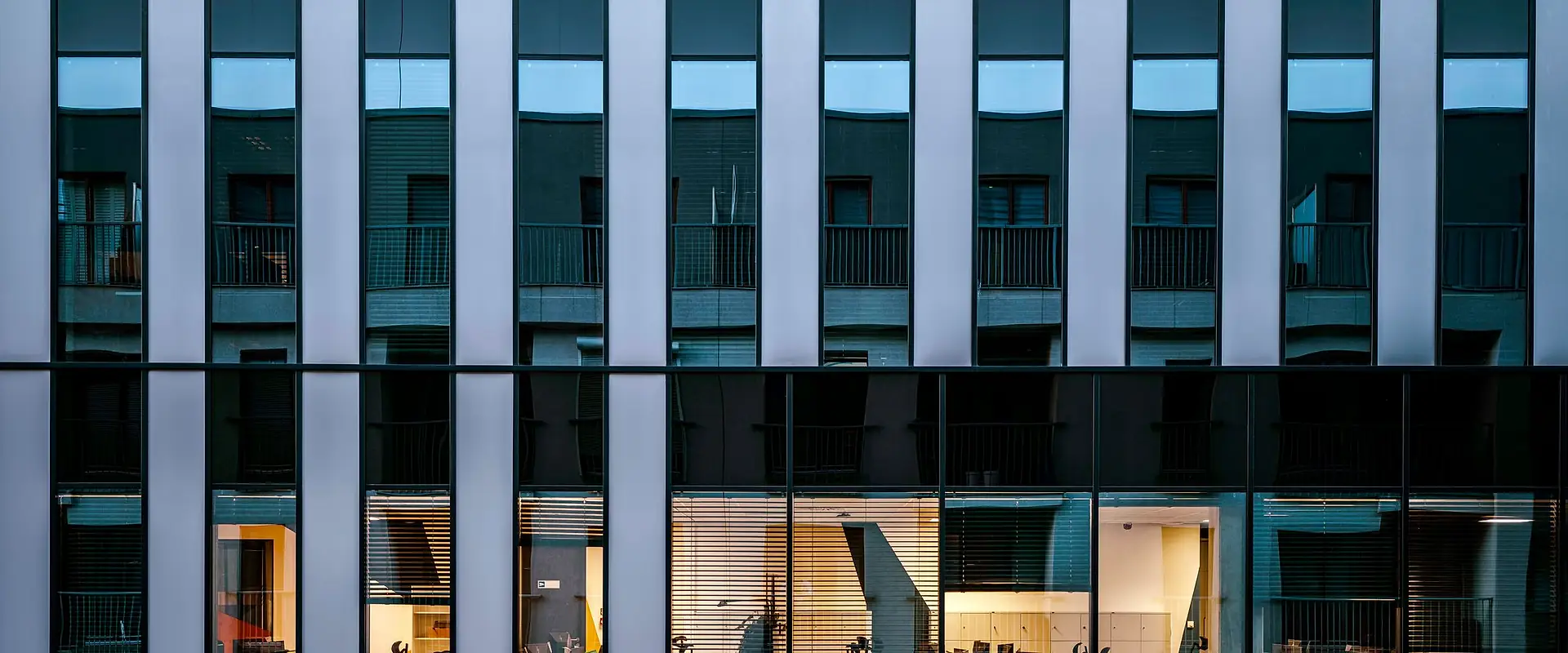Commercial building façade with vertical fins and glazed ground floor
